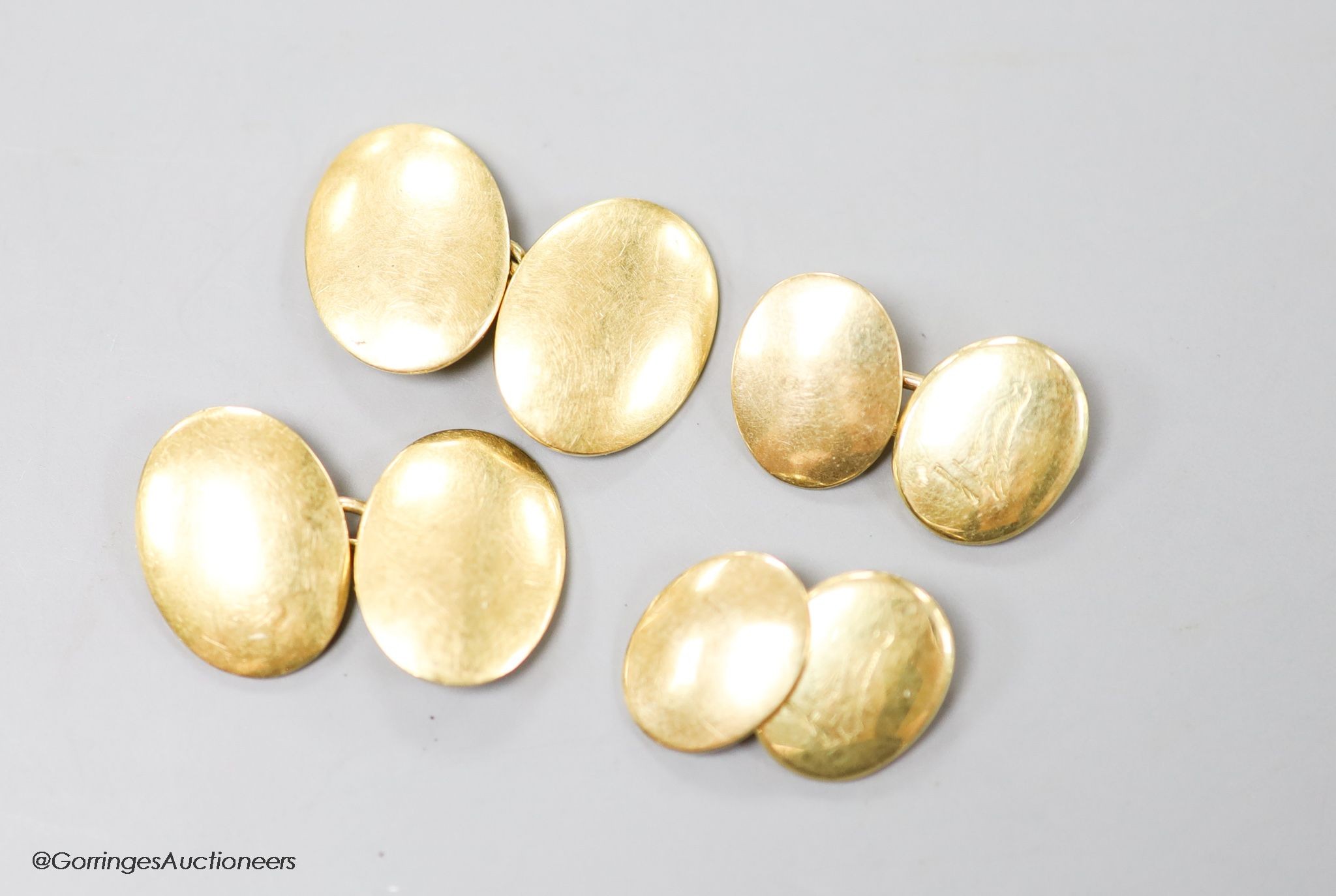 A pair of 18ct oval cufflinks, 12.7 grams and one other pair of yellow metal oval cufflinks, 5.6 grams.